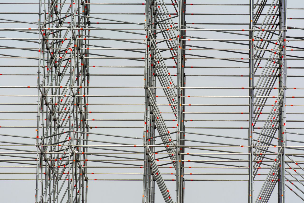 Close-up view of modern steel scaffolding displaying linear patterns and intersections.