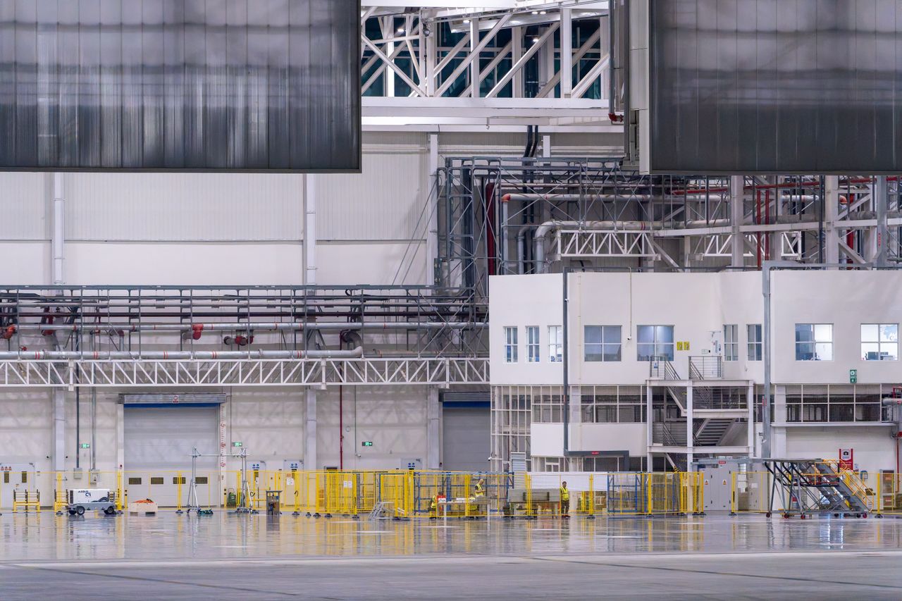 Spacious modern factory interior showcasing industrial manufacturing machinery.