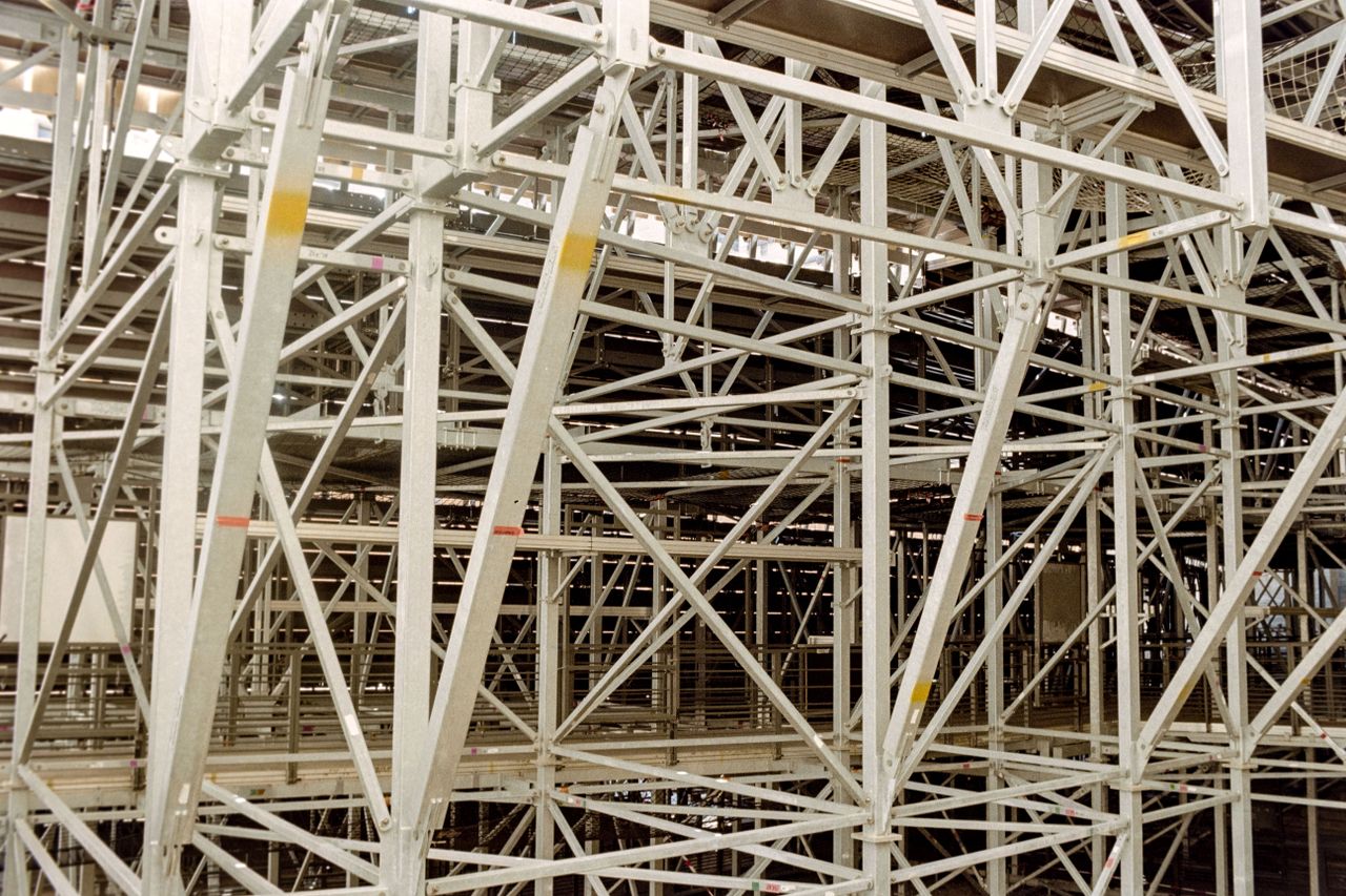 Intricate metal scaffolding structure indoors, showcasing robust industrial architecture.